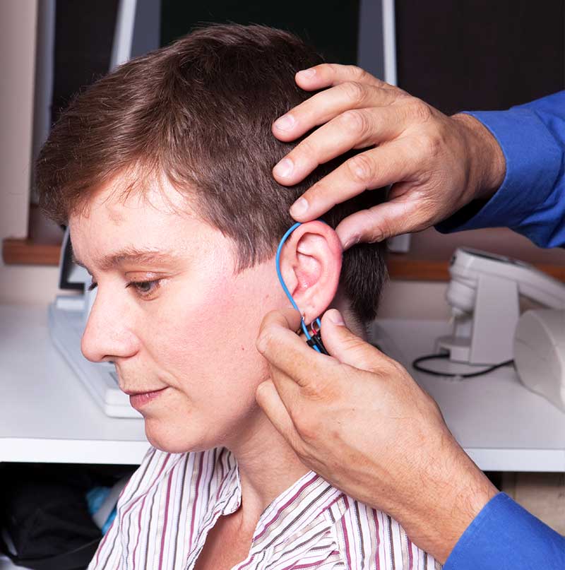 A Real Ear measurement test being performed by an hearing aid specialist.